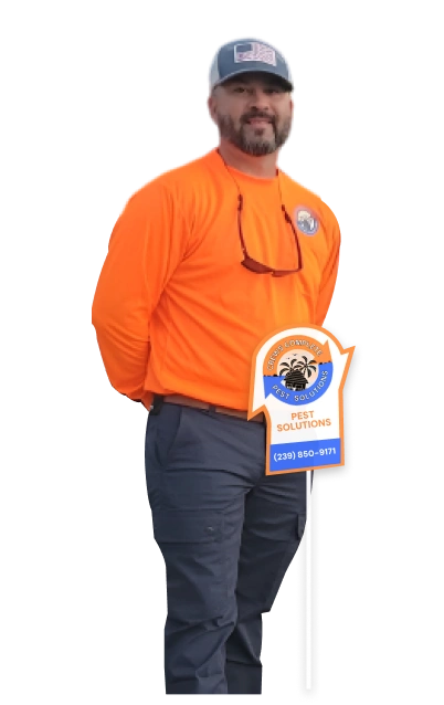 Crews Complete Pest Solutions technician standing in uniform next to a service sign.