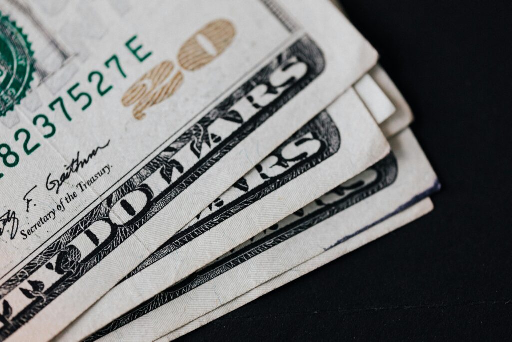 Closeup of USA 20 dollar banknotes placed on black background as national currency for business and personal financial operations